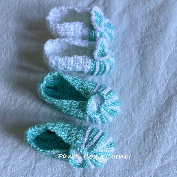 White and light blue crochet baby booties