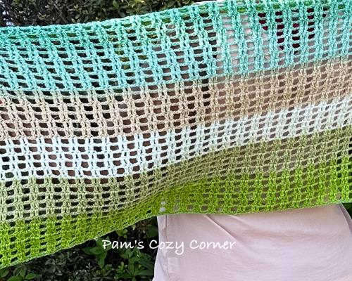 Close-up of lacy crochet stitch pattern in lightweight scarf design