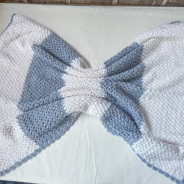 Cozy bean stitch crochet baby blanket in DK weight yarn with modern two-color styling and textured stitches.